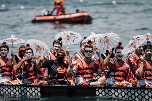 HONG KONG - JULY 05:  Competitors dressing in costumes paddle their boats during the Hong Kong Airlines Fancy Dress Race at the Hong Kong Dragon Boat Carnival Race on July 5, 2015 in Hong Kong, Hong Kong. The Hong Kong Dragon Boat Carnival will be staged from 3 July 2015 (Friday) to 5 July 2015 (Sunday). The carnival featured two key programmes: the CCB (Asia) Hong Kong International Dragon Boat Races in Victoria Harbour and the San Miguel BeerFest at the UC Centenary Garden in East Tsim Sha Tsui.  (Photo by Anthony Kwan/Getty Images for Hong Kong Images)